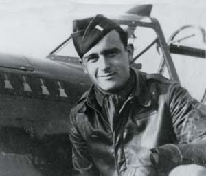 fortier_bud American war pilot, Bud Fortier, shows off his leather jacket for the camera. It protects the pilot from shrapnel if something goes wrong, and it's warm and toasty even at 20,000 feet.