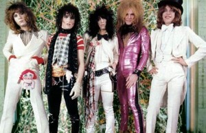 newyorkdolls The New York Dolls show off their wild hair, brightly colored one-piece suits, and leather bands.
