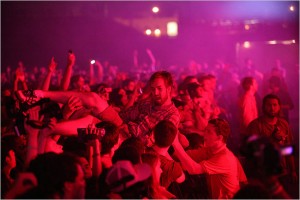 Being at a punk show is more about attitude than dress. This guy looks like a hippie, but he's crowd surfing!