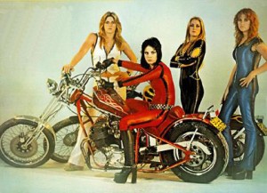 therunaways The motorcycle and the flashiness of their clothing is what's interesting. You hardly notice that there's not a lot of skin showing.
